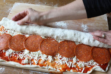 pizza-on-a-stick03. Roll the dough into a log, starting at the long end.